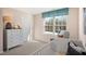 Cozy Bedroom with a crib, dresser, and a large window at 261 Holton St, Smithfield, NC 27577