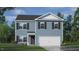 Two-story home featuring blue siding, white trim, dark shutters, and an attached two-car garage at 261 Holton St, Smithfield, NC 27577