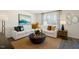 Cozy living room with a sofa, stylish decor, large windows, and natural light at 261 Holton St, Smithfield, NC 27577