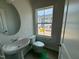 Half bathroom featuring a pedestal sink, toilet, and large window with neighborhood view under construction at 304 Chesapeak Commons St # 146, Garner, NC 27529