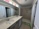 Modern bathroom with double sink vanity, large mirror, and tiled walk-in shower in a new home at 304 Chesapeak Commons St # 146, Garner, NC 27529