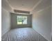 Bright and airy bedroom with tray ceiling, large window with backyard view in a newly constructed home at 304 Chesapeak Commons St # 146, Garner, NC 27529