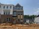 Newly constructed two-story townhouse featuring a brick facade with multiple windows and an inviting entryway at 304 Chesapeak Commons St # 146, Garner, NC 27529