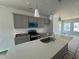 Modern kitchen with gray cabinets, quartz countertop island, subway tile backsplash, and stainless steel appliances at 304 Chesapeak Commons St # 146, Garner, NC 27529