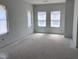 Unfinished living room featuring ample natural light from three large windows at 304 Chesapeak Commons St # 146, Garner, NC 27529