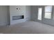 Unfinished living room with fireplace feature, a door, and windows at 304 Chesapeak Commons St # 146, Garner, NC 27529