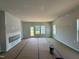 Spacious living room with natural light, fireplace, and doors leading to outdoor space; under construction at 304 Chesapeak Commons St # 146, Garner, NC 27529