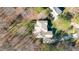 Aerial view showing the house surrounded by a well-maintained lawn and mature trees at 4009 Brittabby Ct, Raleigh, NC 27606