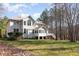 Backyard view of the house, featuring a screened in porch and stairs to the yard at 4009 Brittabby Ct, Raleigh, NC 27606