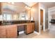 A bathroom with double sinks, granite counters, custom cabinets, and a view into an adjoining room at 4009 Brittabby Ct, Raleigh, NC 27606