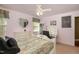 Bedroom with a ceiling fan, large window, a bed with patterned bedding, and a small desk at 4009 Brittabby Ct, Raleigh, NC 27606