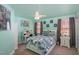 Bedroom with colorful walls, a ceiling fan, a comfortable bed, and matching furniture at 4009 Brittabby Ct, Raleigh, NC 27606