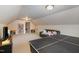 Spacious bonus room with a couch, ping pong table, and a large bookcase at 4009 Brittabby Ct, Raleigh, NC 27606