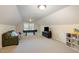 A bonus room or attic space with a sofa, play piano, television, and built-in storage at 4009 Brittabby Ct, Raleigh, NC 27606