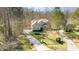 Attractive two-story home with a long driveway, manicured lawn and mature trees in a serene setting at 4009 Brittabby Ct, Raleigh, NC 27606