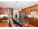 Spacious kitchen with a large island, dark wood cabinets, stainless steel appliances, and granite countertops at 4009 Brittabby Ct, Raleigh, NC 27606