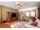 Spacious living room with hardwood floors, large sectional couch, and entertainment center at 4009 Brittabby Ct, Raleigh, NC 27606