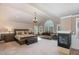 Spacious main bedroom with a sitting area, fireplace, chandelier, and abundant natural light at 4009 Brittabby Ct, Raleigh, NC 27606