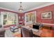 Bright and airy office with large windows, desk, and comfortable seating area at 4009 Brittabby Ct, Raleigh, NC 27606