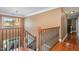 Detailed view of staircase with hardwood steps, decorative iron railings, and a chandelier at 4009 Brittabby Ct, Raleigh, NC 27606