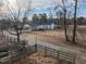 Aerial view of fenced paddocks, pastures, and white farmhouse on a large property at 4063 Nc-39, Selma, NC 27576