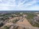 This aerial view highlights the large property, pond, and the surrounding wooded areas at 4063 Nc-39, Selma, NC 27576