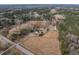 High-angle shot captures a large estate with a pond and surrounding greenery at 4063 Nc-39, Selma, NC 27576