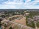 Vast aerial view of a home nestled among trees, featuring a pond and sprawling fields at 4063 Nc-39, Selma, NC 27576