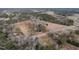 This aerial view highlights the large property, pond, and the surrounding wooded areas at 4063 Nc-39, Selma, NC 27576
