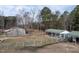 An aerial view of the barns and pasture, surrounded by mature trees and fencing at 4063 Nc-39, Selma, NC 27576
