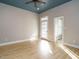 Bedroom with blue ceiling and hardwood floors at 4063 Nc-39, Selma, NC 27576