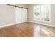 Bedroom with sliding barn door and hardwood floors at 4063 Nc-39, Selma, NC 27576