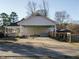 Spacious driveway leading to a covered parking area, with a seating area visible in the background at 4063 Nc-39, Selma, NC 27576