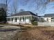 Inviting white home with a porch, ceiling fans, and a well-maintained yard at 4063 Nc-39, Selma, NC 27576