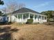 Quaint white home featuring a covered porch and well-manicured lawn at 4063 Nc-39, Selma, NC 27576