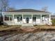 Charming front exterior with a porch and pillars, decorative fans and a black front door at 4063 Nc-39, Selma, NC 27576