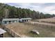 A high angle view of a horse barn facility featuring fenced paddocks and trees at 4063 Nc-39, Selma, NC 27576
