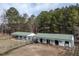 Equestrian barn facility with a green roof and fenced paddocks at 4063 Nc-39, Selma, NC 27576
