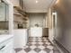 Bright, remodeled kitchen with stainless appliances, checkerboard floors, and white cabinets at 4063 Nc-39, Selma, NC 27576