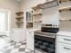 This contemporary kitchen features stainless appliances, open shelving, and checkered flooring at 4063 Nc-39, Selma, NC 27576
