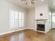 Living room features a ceiling fan, brick fireplace, and shuttered windows at 4063 Nc-39, Selma, NC 27576