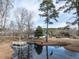 A scenic pond on the property features mature trees and a small dock for peaceful enjoyment at 4063 Nc-39, Selma, NC 27576