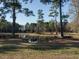 Picturesque pond surrounded by mature trees and lush greenery at 4063 Nc-39, Selma, NC 27576