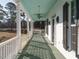 Inviting porch with a swing, ceiling fans, and a charming white railing at 4063 Nc-39, Selma, NC 27576