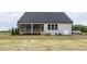 Home exterior showcases a screened-in porch and a lush green backyard at 409 Grading Stick Ct, Angier, NC 27501