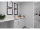 Stylish wet bar with white cabinets, quartz countertop, and decor for casual entertaining at 409 Grading Stick Ct, Angier, NC 27501