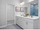 Bathroom with double vanity and walk-in shower, all in a white and gray color scheme at 409 Grading Stick Ct, Angier, NC 27501