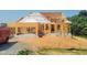 New home construction featuring a framed house with two construction workers on the roof and open blue sky at 409 Grading Stick Ct, Angier, NC 27501