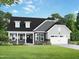Charming single Gathering home featuring lush landscaping and a front-facing attached garage at 409 Grading Stick Ct, Angier, NC 27501