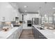 Modern kitchen featuring quartz countertops, stainless steel appliances, and a gray and white color scheme at 409 Grading Stick Ct, Angier, NC 27501